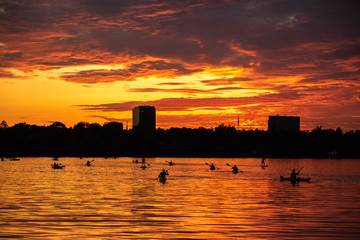Bucharest sunset on Herastrau lake with kayak , people having relaxing and fun time 