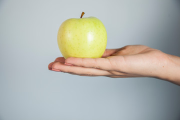 woman hand holding green apple