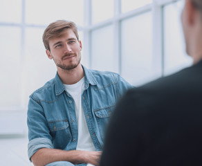 young man interviews a guest in the Studio.