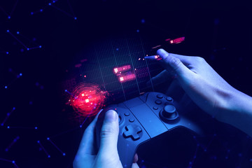 gamer boy with hand holding the joystick controller electronic for playing game with online network connection  technology device in esport tournament challenge concept © issaronow
