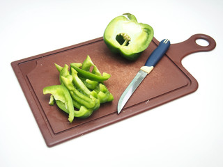 Green pepper fruit lies on the cutting Board.