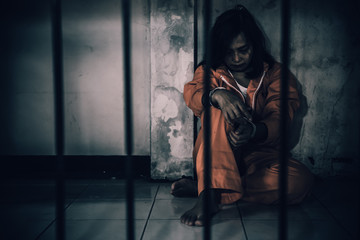 Portrait of women desperate to catch the iron prison,prisoner concept,thailand people,Hope to be free,If the violate the law would be arrested and jailed.