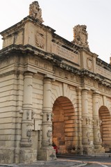 Floriana, Malta, August 2019. Fragment of the triumphal gate at dawn close-up.