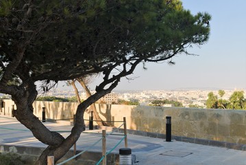 Fototapeta na wymiar Floriana, Malta, August 2019. View from the botanical garden of the surrounding cities.