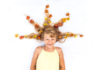 charming smiling child with healthy and strong long blond hair in shape of spike with floral...