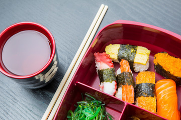 Lunch box served with soy sauce and chopsticks