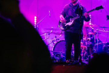 Fototapeta na wymiar Guitar player rocking on a stage