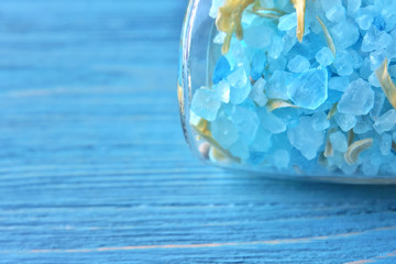 Amazing blue salt in crystal on blurred blue background. Mineral saline sodium chloride. Organic...