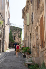 Fototapeta premium small street alley Village of Bonnieux in Provence France with tourist