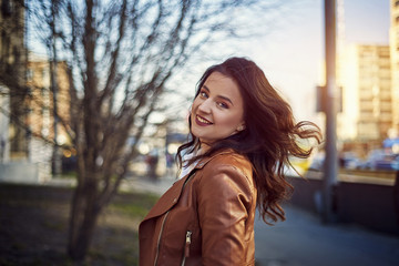 Fototapeta premium Classic beauty portrait of young woman with blue eyes and dark hair, weared in white shirt and jacket. Street shot