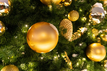 Obraz na płótnie Canvas Decorated Christmas tree close up details. Christmas tree lights and toys