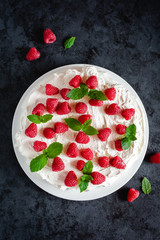 Meringue with whipped cream, raspberries.and mint