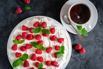 Meringue with whipped cream, raspberries.and mint