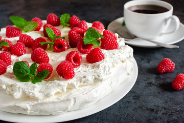 Meringue with whipped cream, raspberries.and mint