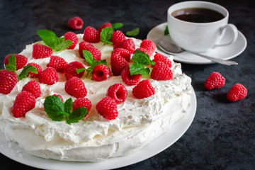 Meringue with whipped cream, raspberries.and mint