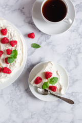 Meringue with whipped cream, raspberries.and mint