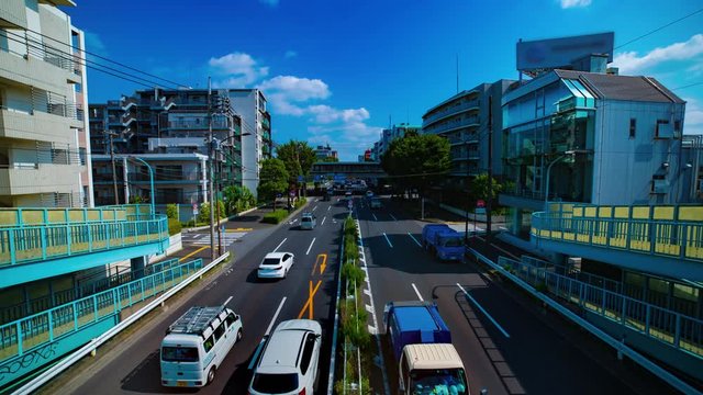 A timelapse of downtown street at Kanpachi avenue in Tokyo daytime wide shot tilt