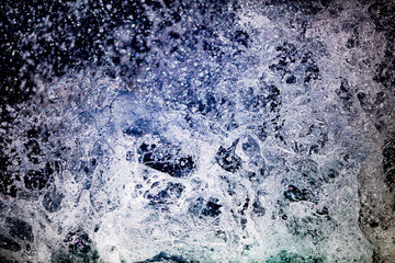 The texture of the blue waters of a rough sea with splashes, foam and waves in the Atlantic ocean in Ireland