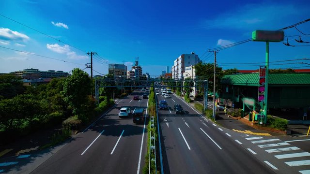 A timelapse of downtown street at Kanpachi avenue in Tokyo daytime wide shot tilt