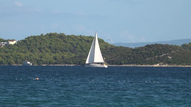 SEGET DONJI, CROATIA-September 2019: yacht is sailing along the island in the Adriatic Sea. Sailing boat at sea, side view.