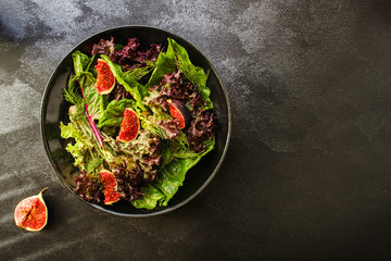 healthy salad figs, cheese, lettuce (arugula, spinach and other ingredients, snack, healthy food) menu concept. food background. copy space. Top view