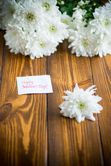 bouquet of white chrysanthemums on wooden table