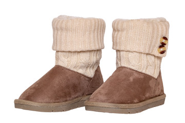 Winter boots. Close-up of a pair elegant brown suede leather winter boots with wool and lined with fur. Girls winter shoe fashion new collection. Isolated on a white background. Macro.