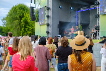 Couple is watching concert at open air music festival