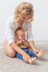 Cute single mother and kid girl playing together indoor at home