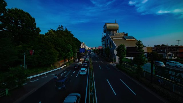 A timelapse of downtown street at Kanpachi avenue in Tokyo daytime wide shot tilt