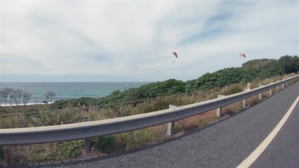 Paragliders Paragliding. People Para Gliding & Flying High In Windy Cloudy Sky Off Lennox Point Headland Sea Coastline Hills.Popular Outdoor Leisure Activity Sport. Lennox Head Landscape Australia NSW