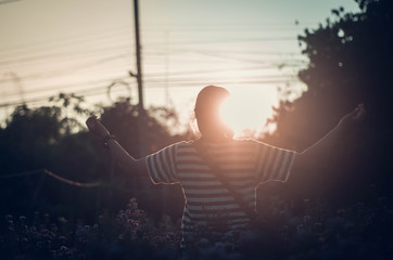women raise their arms thank God along with praising God