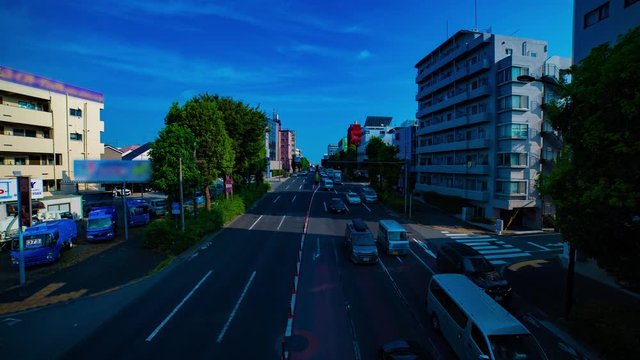 A timelapse of downtown street at Kanpachi avenue in Tokyo daytime wide shot tilt