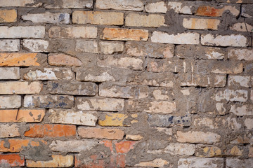 Roughly curved brickwork stained with frozen mortar