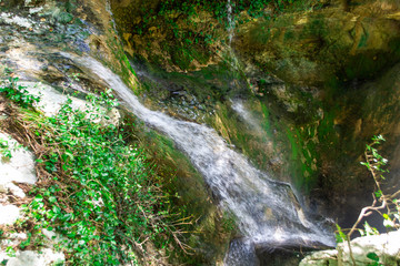 Small waterfall from the rock cliff in the national park.