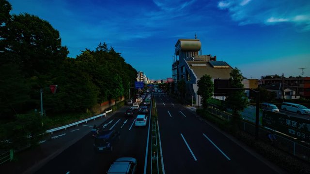 A timelapse of downtown street at Kanpachi avenue in Tokyo daytime wide shot tilt