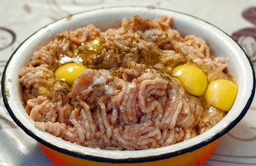 Cooking - minced meat for homemade meatballs with broken raw eggs