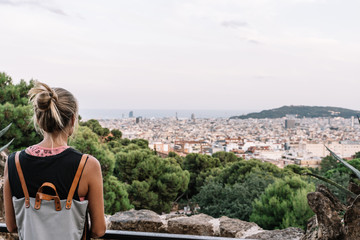 Rear view of a blond woman looking at barcelona city view