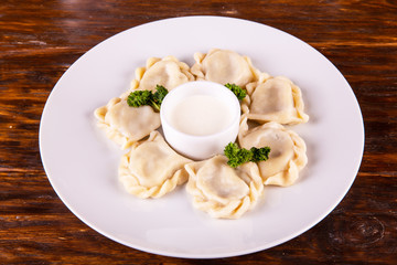 Vareniki meat, are served with sour cream and parsley