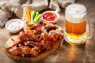 plate of grilled chicken wings and mug of beer