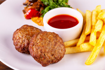 Cutlets with ketchup and French fries