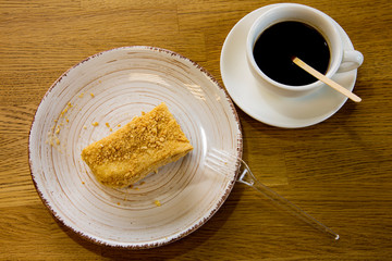 cup of coffee and cake on wooden table