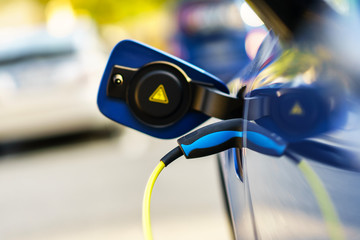 Electric Vehicle is Charging on Parking Lot 
