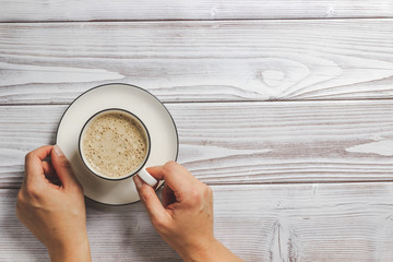 Female hands holding a cup of coffee