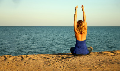 Woman relaxing on beach during sunset