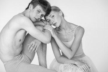 Beautiful couple of ballet dancers lifestyle portrait over white studio background