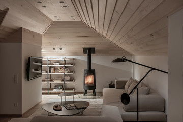 Light illuminated interior with sloping wooden ceiling