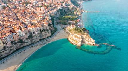 Tropea, Calabria - Aerial view of the Italian city, monastery and coastline with azure crystal-clear water from drone perspective