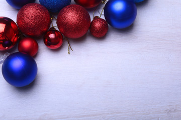 Red and blue christmas balls on a wooden background