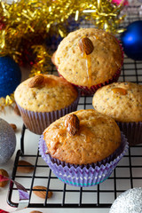 Homemade lemon muffins with poppy seeds and almond in paper case. White background. Selective focus. Christmas concept.